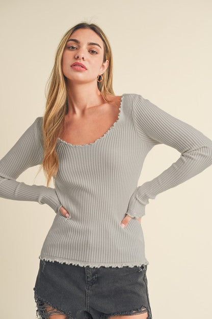 Automotive image showing a Jade Icarus Aemi + Co Lettuce Hem Scoop Neck Long Sleeve Knit Top with detailed lettuce hem and scoop neckline.