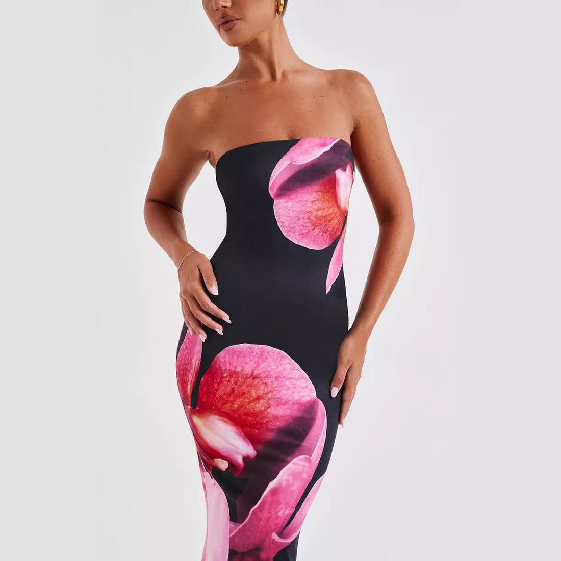 Carmine Juneberry 25 Edition backless floral draped tube maxi dress displayed on a model, featuring vibrant floral patterns and a flowing silhouette.