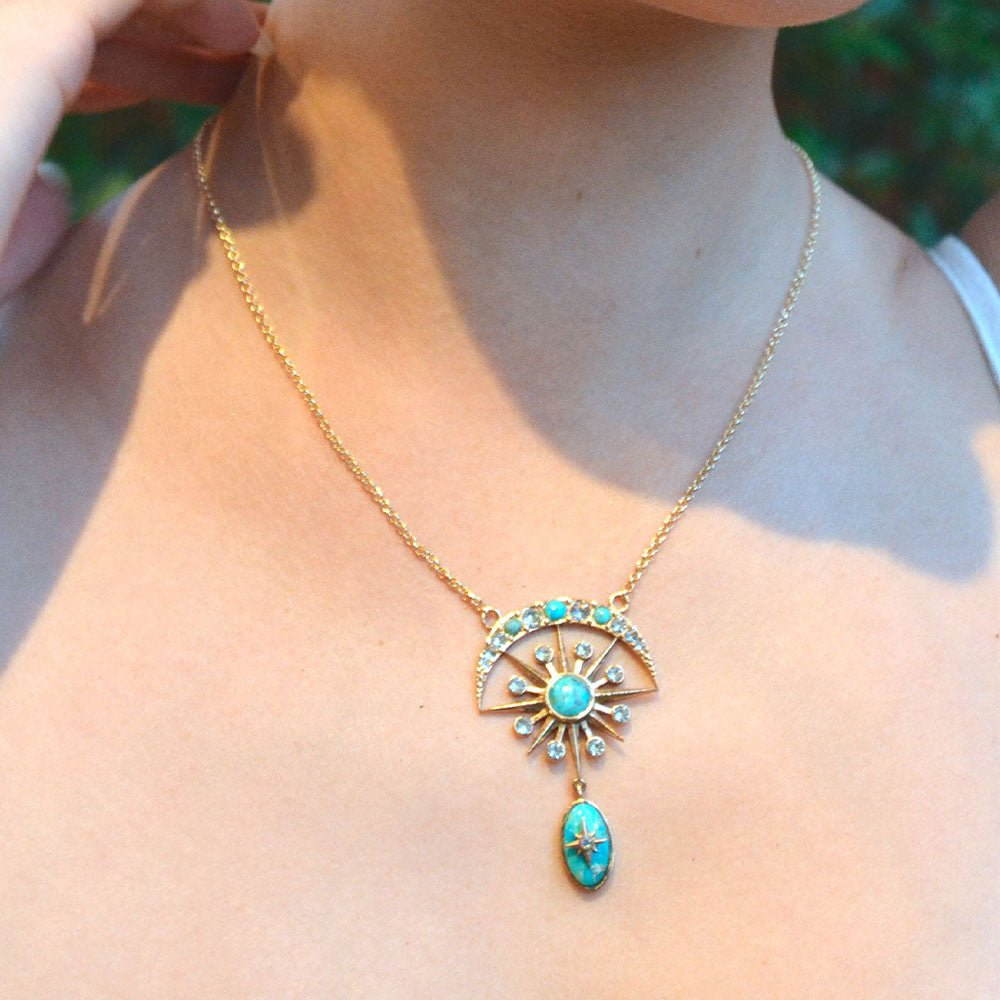 Celestial Blue turquoise and gold drop necklace from Start2Finish featuring a vibrant turquoise pendant with gold accents.
