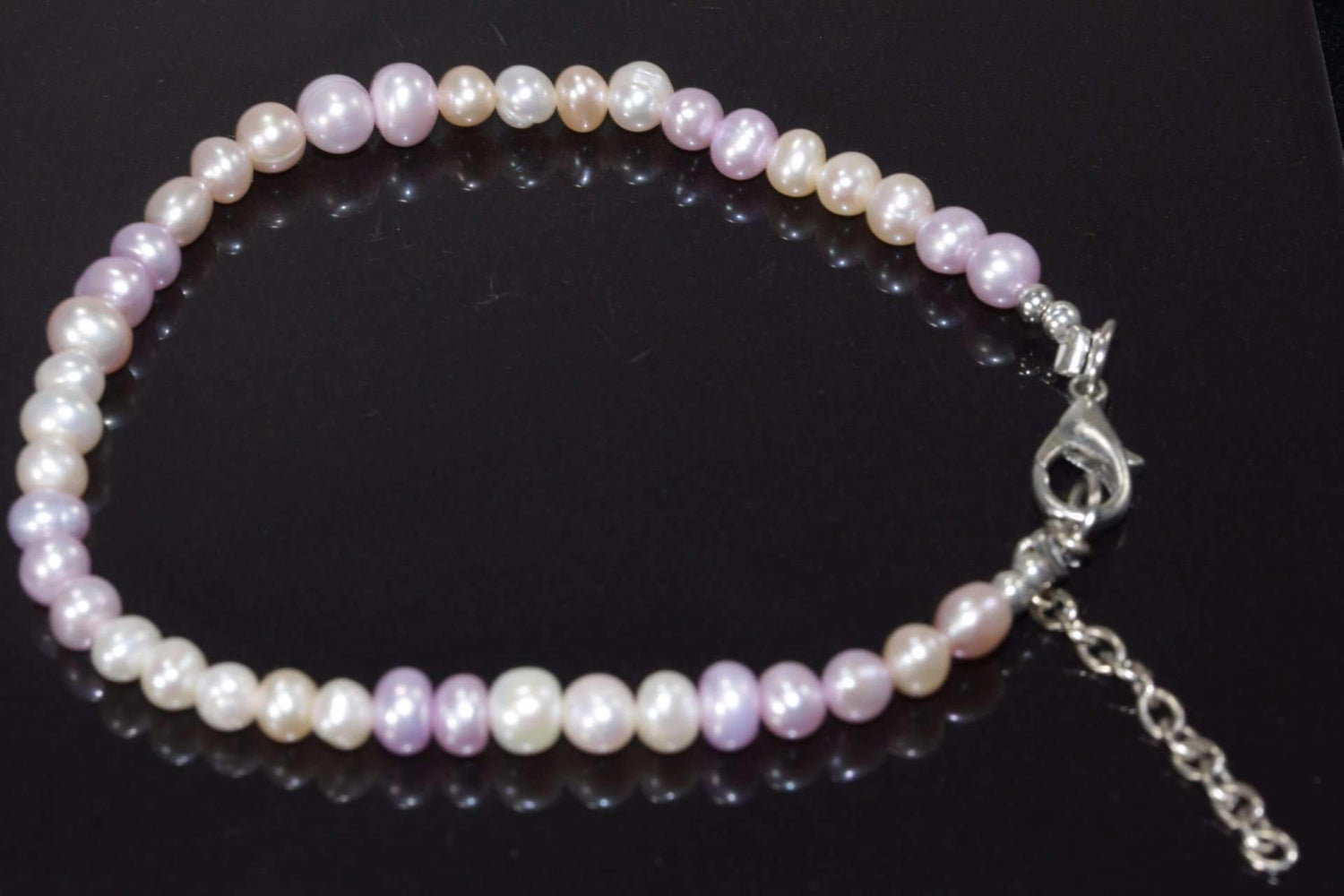 Pearly Pink Sands Bracelet by Silver Hestia featuring pink sand-colored beads and silver accents on a delicate bracelet.