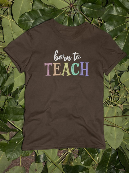 Born To Teach chalk text T-shirt by Start2Finish, featuring a casual black apparel with white chalk-style lettering.