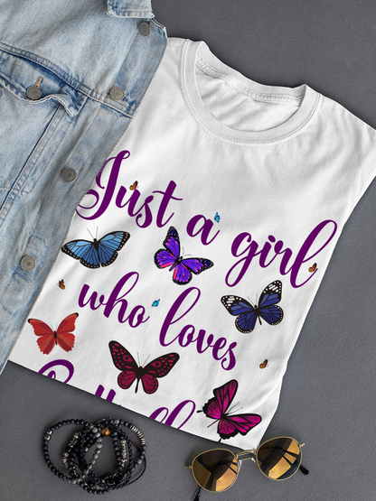 A girl wearing a colorful butterfly graphic T-shirt by Start2Finish, featuring vibrant butterfly illustrations on the apparel.