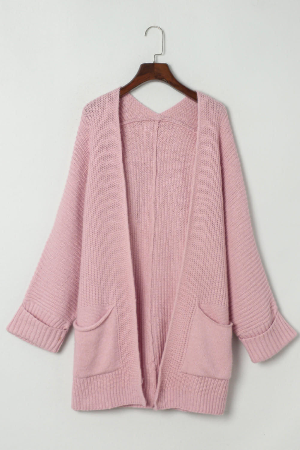 Pink oversized fold-over sleeve open front cardigan by Carmine Juneberry, featuring a relaxed fit and cozy knit fabric.