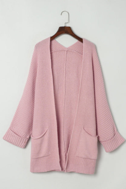 Pink oversized fold-over sleeve open front cardigan by Carmine Juneberry, featuring a relaxed fit and cozy knit fabric.