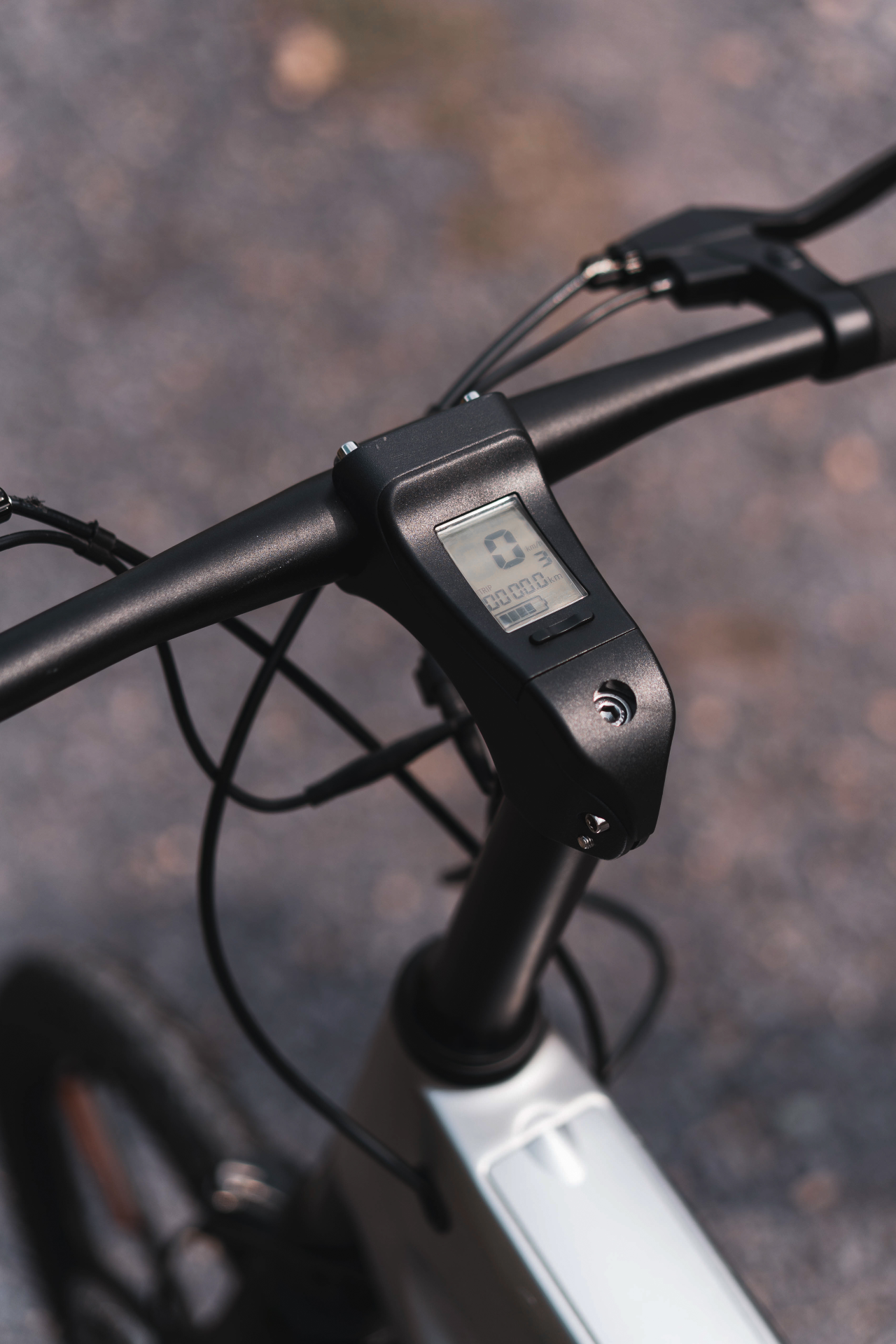 Start2Finish Racing White E-Bike with built-in speakers and Bluetooth, showcasing the sleek design and handlebars.