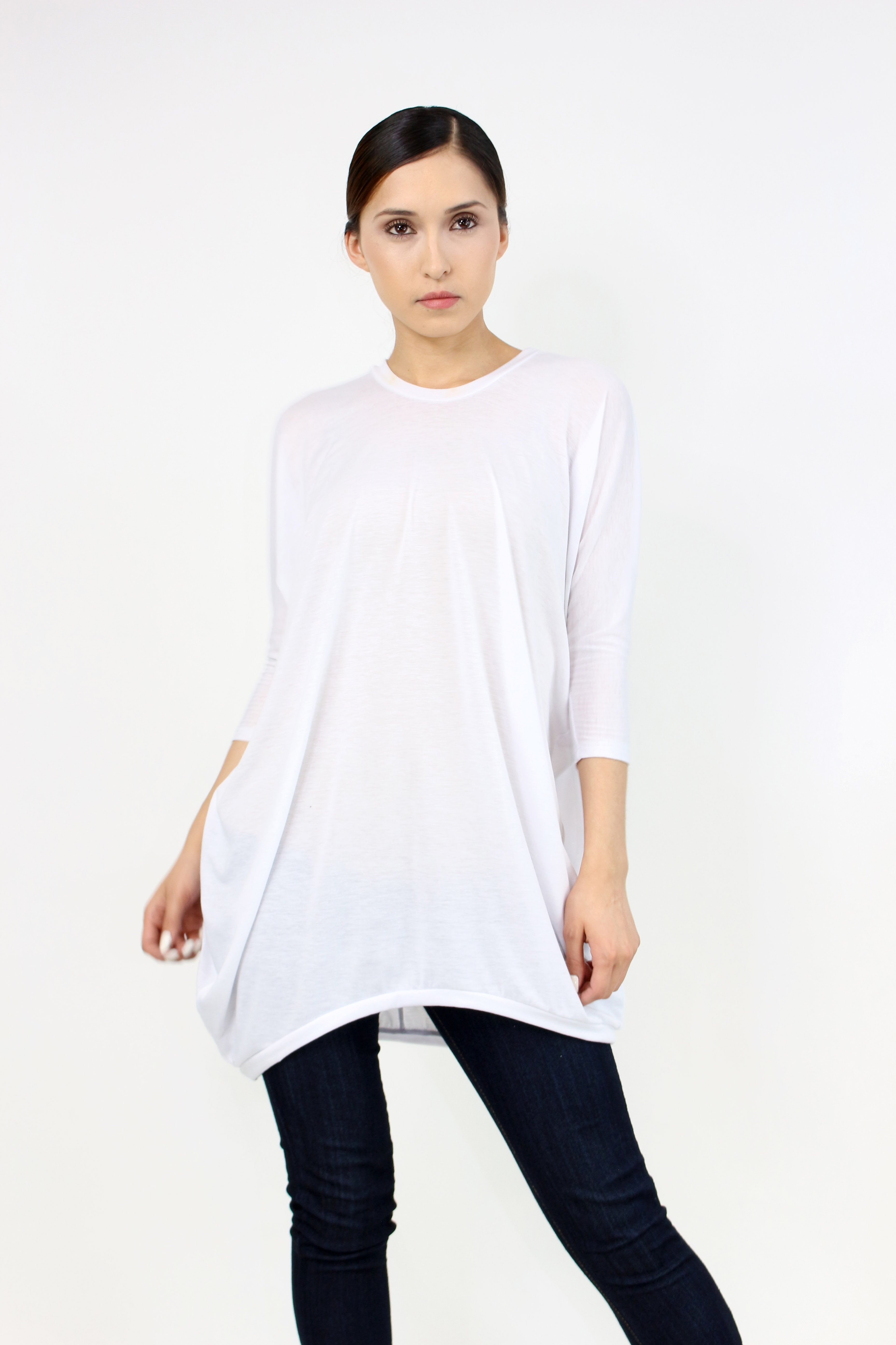 White oversized shirt dress by Yellow Hera, displayed on a hanger, featuring a relaxed fit and classic collar design.