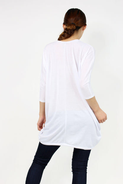 White oversized shirt dress by Yellow Hera, showing a relaxed fit with long sleeves and a classic collar.