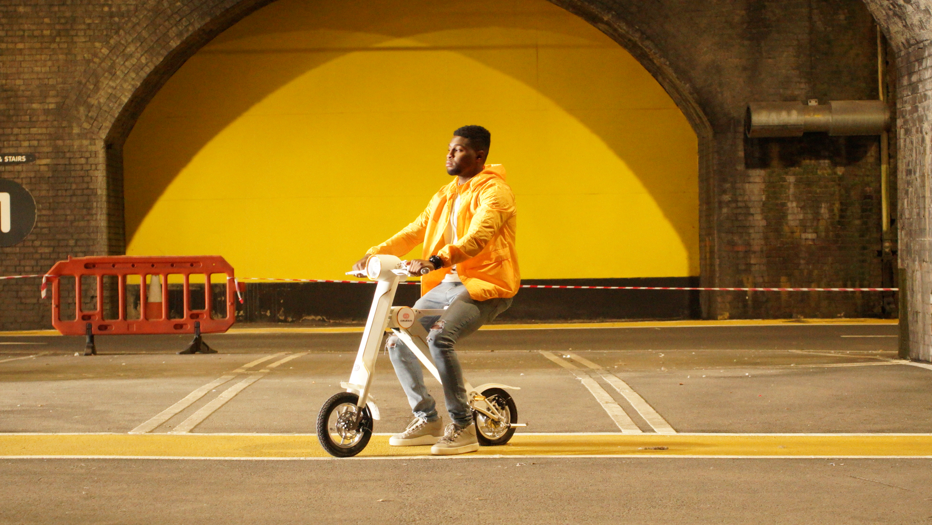 Start2Finish Cruzaa PRO electric scooter in racing white showing handlebars, built-in Bluetooth speakers, USB port, and sleek design.