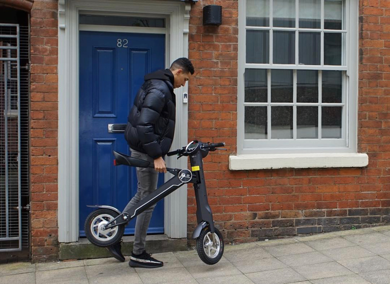 Cruzaa Electric Scooter by Start2Finish with Bluetooth speakers, USB port, 35km range, and 25km/h top speed, shown outdoors.