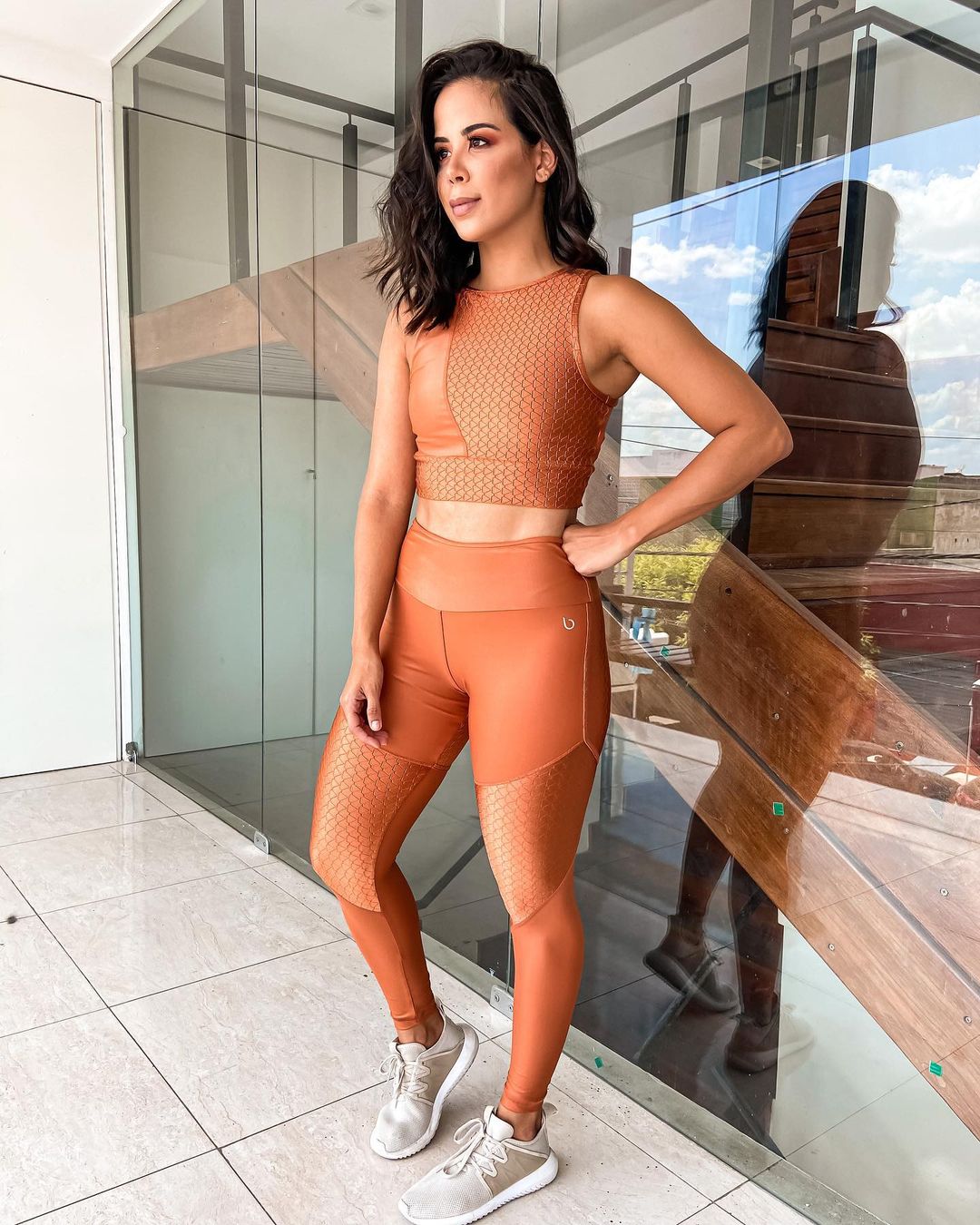 Orange blossom cropped sports bra by Red Medusa, activewear for workout and athletic activities, shown on a hanger.