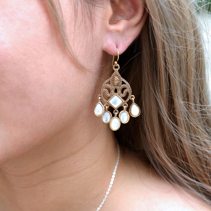 Luscious white mother of pearl and gold chandelier earrings, elegant jewelry with intricate design and dangling pearl accents.