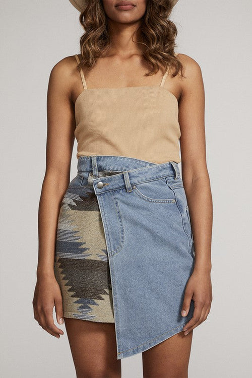 Automotive denim skirt by Jade Icarus with distressed details and casual style, shown on a model in a fashion photoshoot.