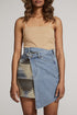 Automotive denim skirt by Jade Icarus with distressed details and casual style, shown on a model in a fashion photoshoot.