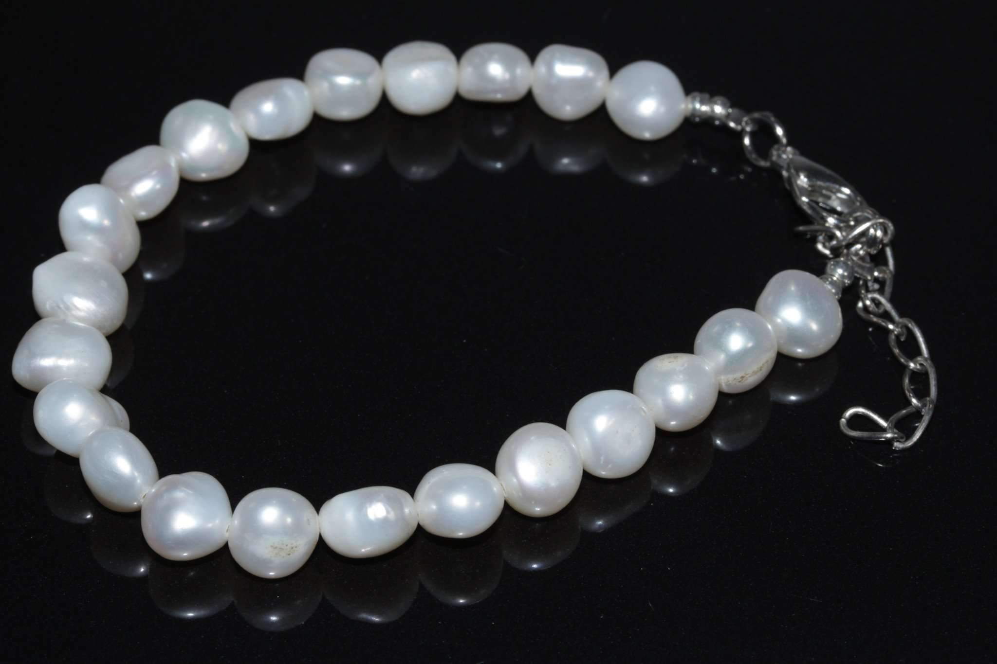Silver Hestia elegant cultured freshwater pearls bracelet with lustrous white pearls and a delicate clasp, showcasing refined jewelry craftsmanship.