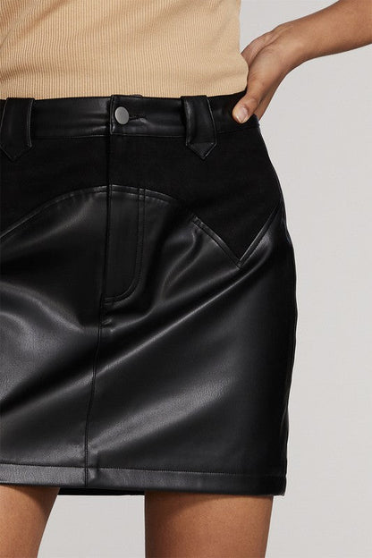 Western contrast pleather mini skirt by Jade Icarus, shown in a stylish automotive-inspired design with black and white color contrasts.
