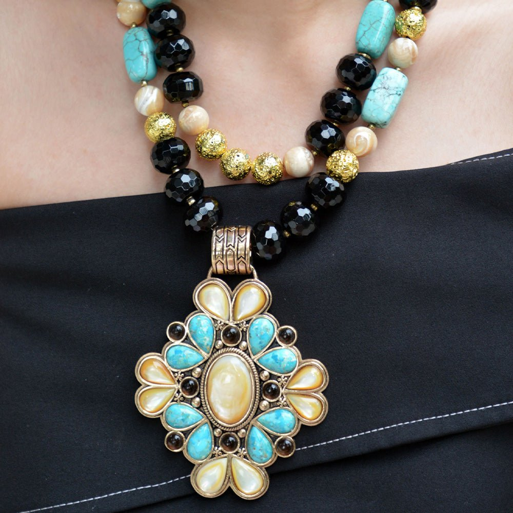 Start2Finish Barcelona Blue Turquoise and Caramel Mother of Pearl pendant necklace with gold accents, featuring a detailed jewelry design.