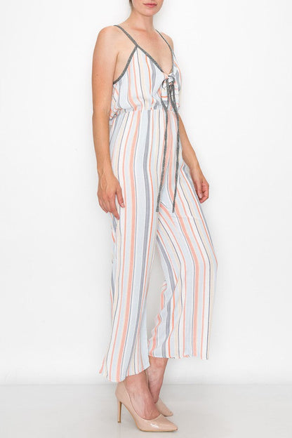 Orange front tie cropped jumpsuit by Yellow Hera, stylish clothing with a fitted waist and cropped length, displayed on a hanger.