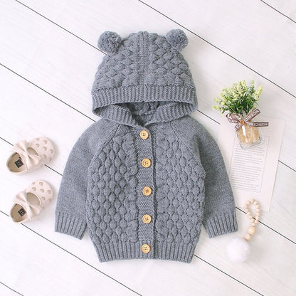 Carmine Juneberry KuschelGlöckchen™ hooded knit baby jacket with pom-pom, soft and cozy for infants.