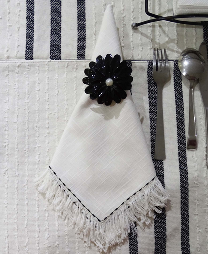 Set of four Start2Finish home table cloth napkins with elegant black embroidery showcasing intricate detailing.