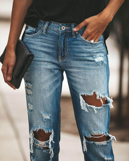 Carmine Juneberry large ripped jeans with distressed details and frayed hems, showcasing a trendy casual denim style.