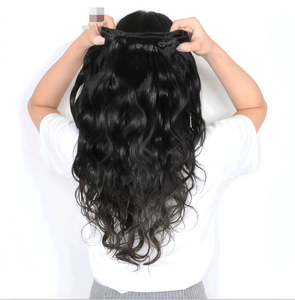 Carmine Juneberry LuxeWave real hair wig and hair extensions styled with soft waves, showcasing luxurious, natural-looking hair.