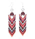Red Sunflower African Chevron earrings with bold geometric patterns and vibrant colors, hanging from silver hooks.
