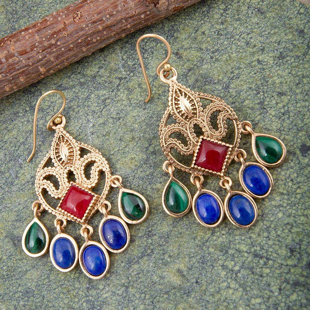 Luscious red quartz golden chandelier earrings with intricate design, shiny gold accents, and dangling red quartz stones.