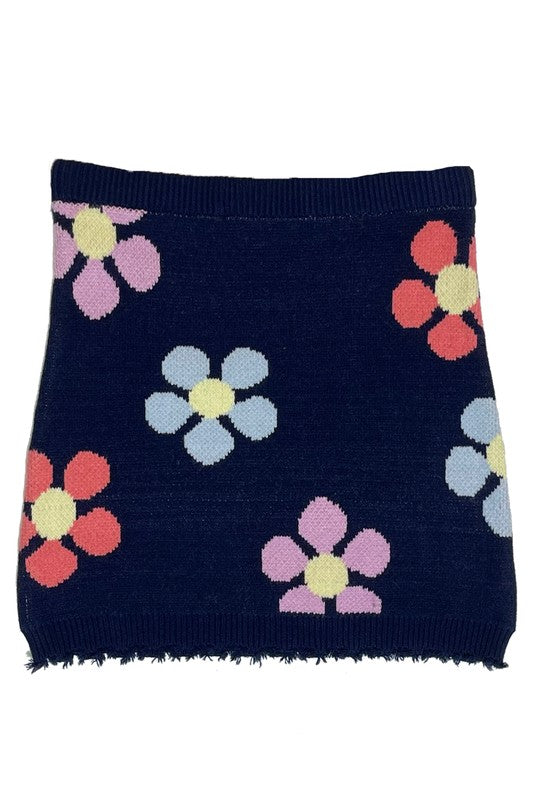 Jade Icarus flower sweater skirt with vibrant floral pattern, displayed on a mannequin, showcasing its colorful knitted design.