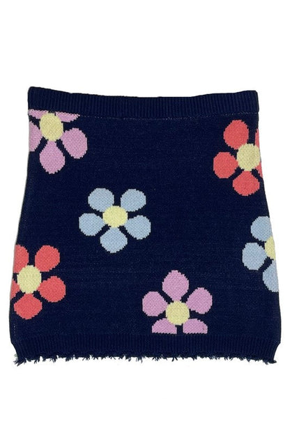 Jade Icarus flower sweater skirt with vibrant floral pattern, displayed on a mannequin, showcasing its colorful knitted design.