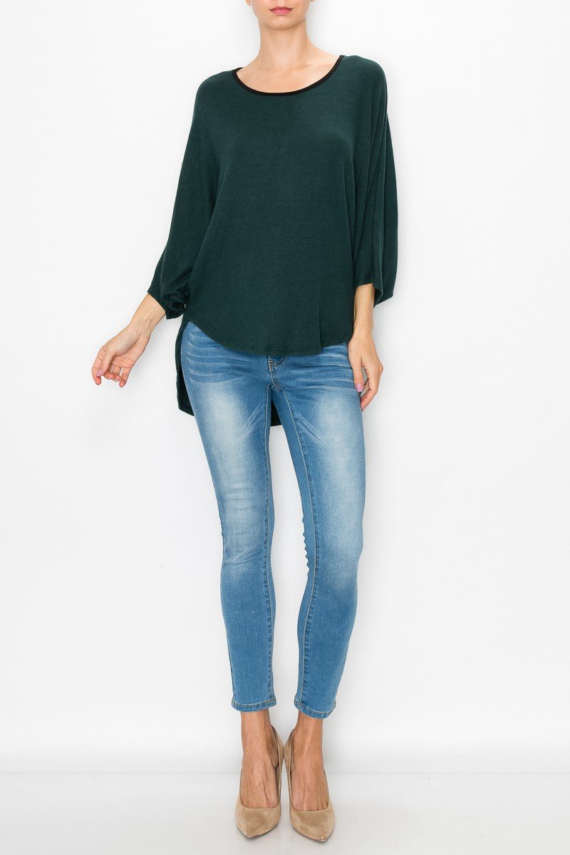 Green high and low round neck tunic top by Yellow Hera, displayed as a stylish dress, with a flowing, asymmetrical hem.