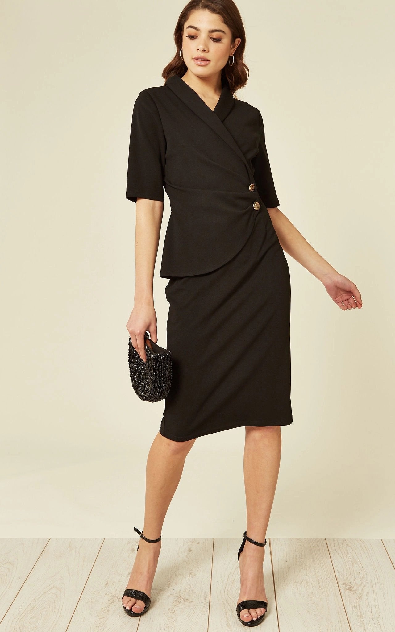 Rose Eleusis Diane Wrap Blazer Dress, black jacket with tailored fit and lapel collar, styled as a sophisticated wrap blazer dress.