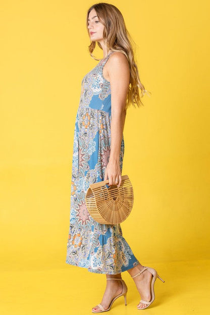 Women’s sleeveless print ruffled hem tea-length dress by Jade Icarus, featuring a flowy silhouette and vibrant pattern.
