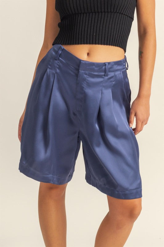 Jade Icarus HYFVE high-waist satin pleated shorts for women, featuring a sleek, shiny fabric and a stylish pleated design.
