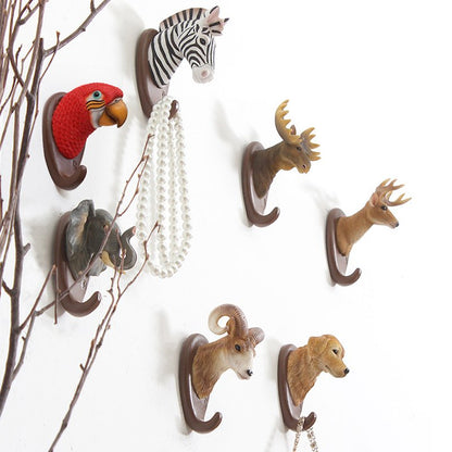 Fuchsia Molly animal wall hook mounted on a wooden wall, decorative home and garden accessory for hanging items.