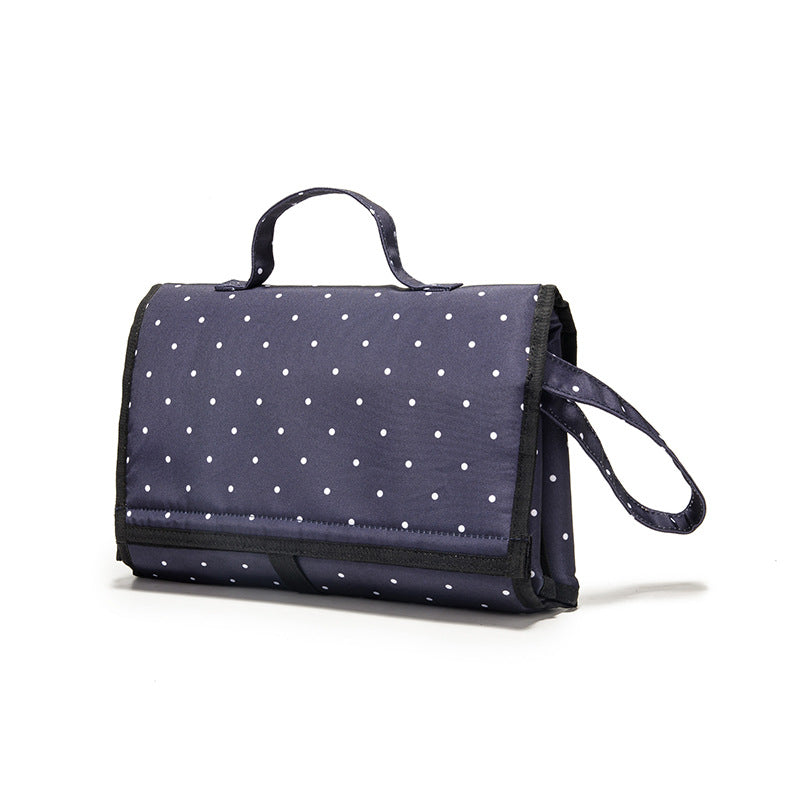 Waterproof portable diaper change pad by Maroon Asteria, featuring multiple compartments and soft surface for travel diaper changes.