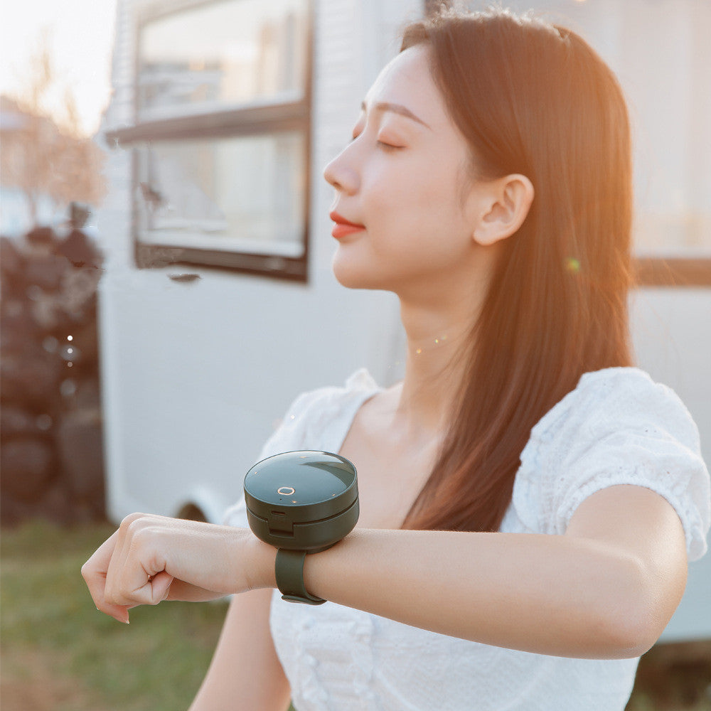 Maroon Asteria portable wrist fan with mirror, leafless design, USB rechargeable, and 3-speed settings for home improvement use.
