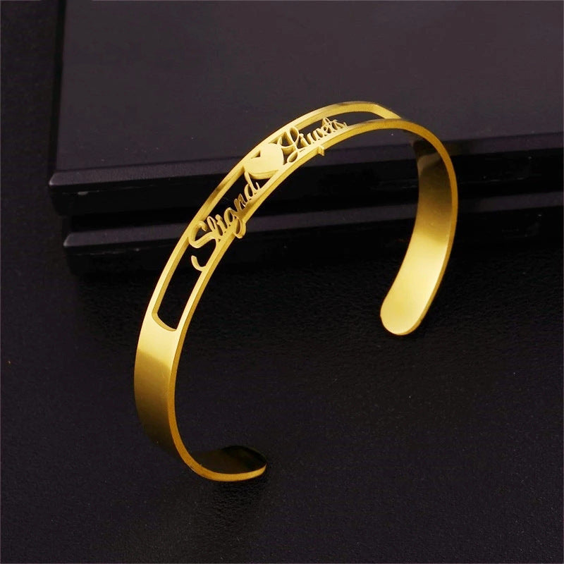 Personalized LuxeJewels™ stainless steel cuff bracelet with custom engraved name, featuring sleek design by Carmine Juneberry.
