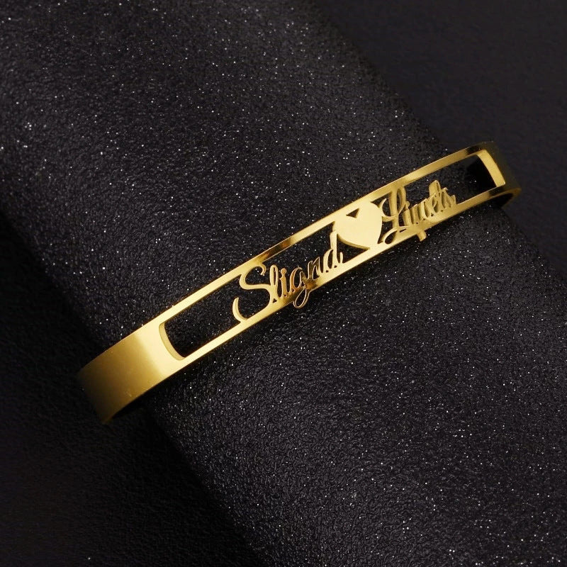 Personalized stainless steel cuff bracelet with custom name from LuxeJewels™ by Carmine Juneberry, featuring sleek, modern design.