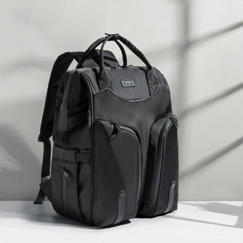 Carmine Juneberry SmartMom Travel+ diaper backpack with multiple compartments and padded shoulder straps for moms on the go.