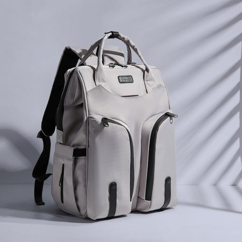 Carmine Juneberry SmartMom Travel+ diaper backpack with multiple compartments and adjustable straps, designed for parents on the go.
