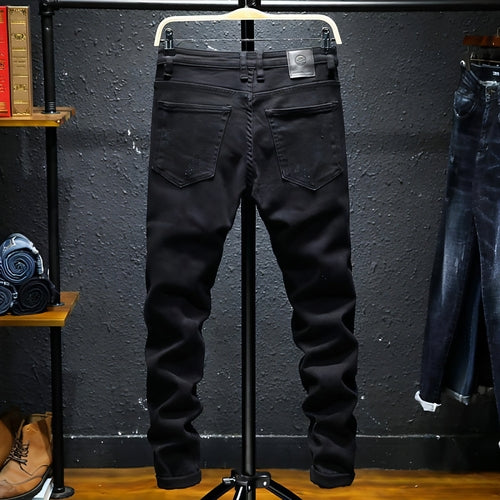 Black DenimDare™ ripped stretch jeans for men by Carmine Juneberry, featuring a slim fit and distressed detailing.