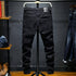 Black DenimDare™ ripped stretch jeans for men by Carmine Juneberry, featuring a slim fit and distressed detailing.