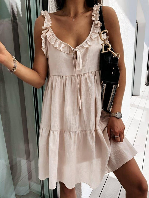 Women’s solid color dress with suspenders and V-neck, featuring a short skirt design by Carmine Juneberry.