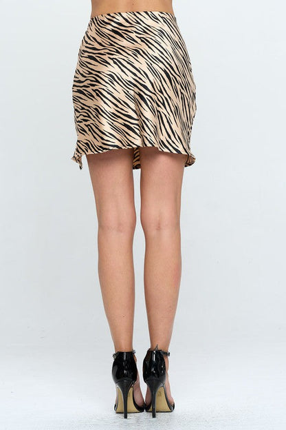 Zebra print satin mini skirt with slit from Jade Icarus, showcasing smooth fabric and stylish design on a white background.