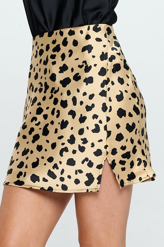 Leopard print satin mini skirt with slit by Jade Icarus, featuring a stylish design and smooth satin fabric.