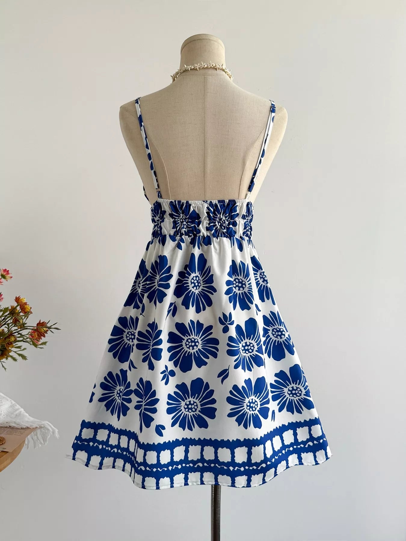 Floral print V-neck mini dress by Pear Daisy, featuring a colorful garden-inspired pattern and lightweight fabric.