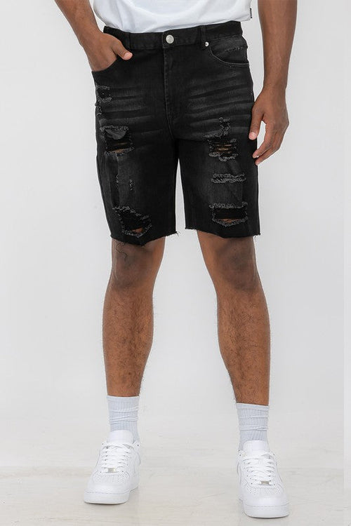 Distressed stretch denim shorts featuring automotive-inspired design by Jade Icarus, shown in a close-up with frayed edges and rugged details.