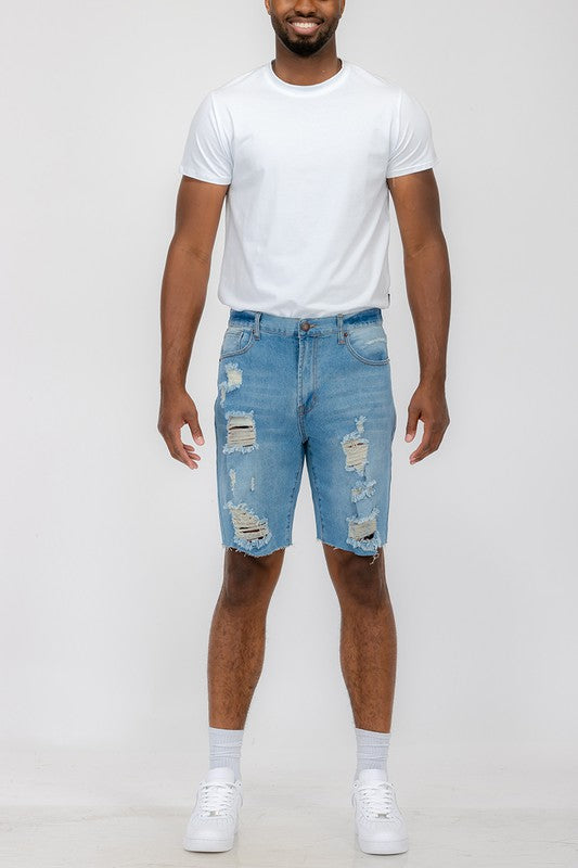 Distressed stretch denim shorts by Jade Icarus with automotive-inspired design, featuring a rugged, worn look and frayed edges.