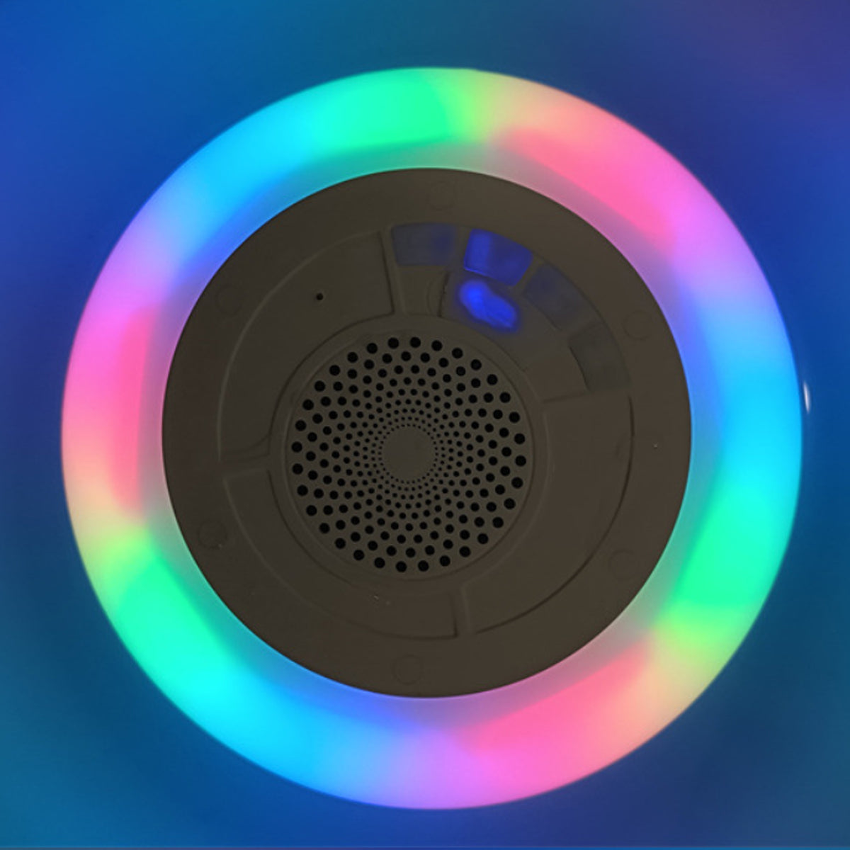Salmon Lucky Floatilla waterproof Bluetooth speaker with LED lights floating in a pool, designed for poolside music and fun.