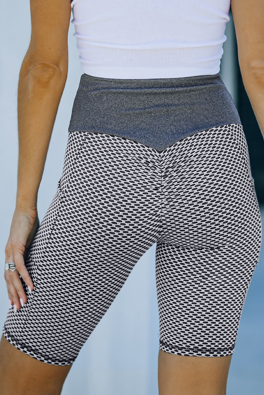 Black ruched yoga shorts with side pockets and butt lifting design by Harlequin Daisy, perfect for active and casual wear.